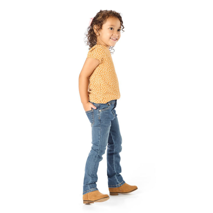 Thin Little Girl Wearing Slim-Fit Kids Jeans with Hands in her Back Pockets