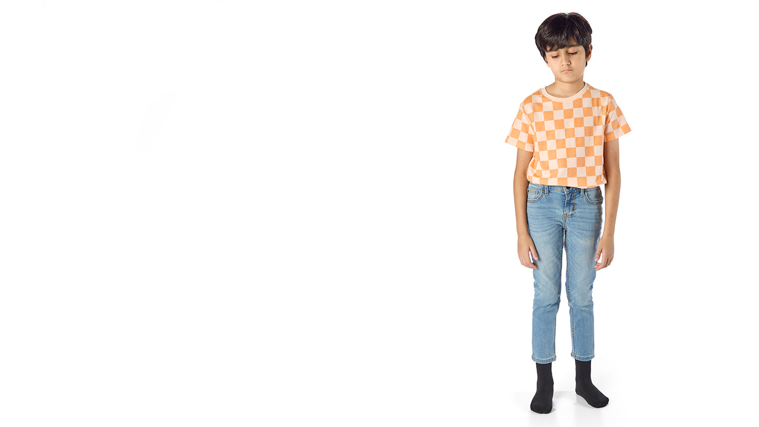 Tall skinny boy showing poor fit of kids denim jeans