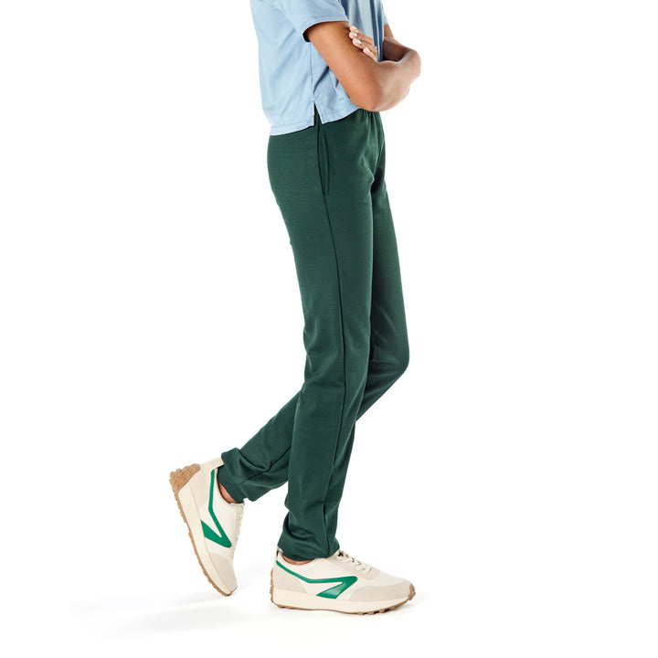 Thirteen-year-old child wearing slim-fit athletic pants designed for tall, skinny kids with pockets and an elastic waist.